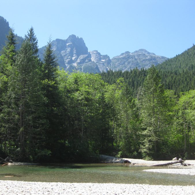 A photo overlooking Gold Creek and Golden Ears Mountain from Viewpoint Beach on a sunny day in Golden Ears Provincial Park in BC.