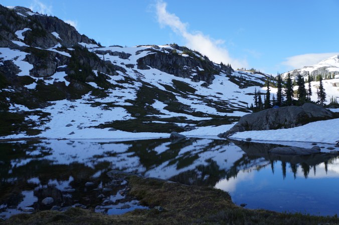 A photo of Semaphore Lakes on a sunny day with lots of snow still clinging to the mountains in BC.