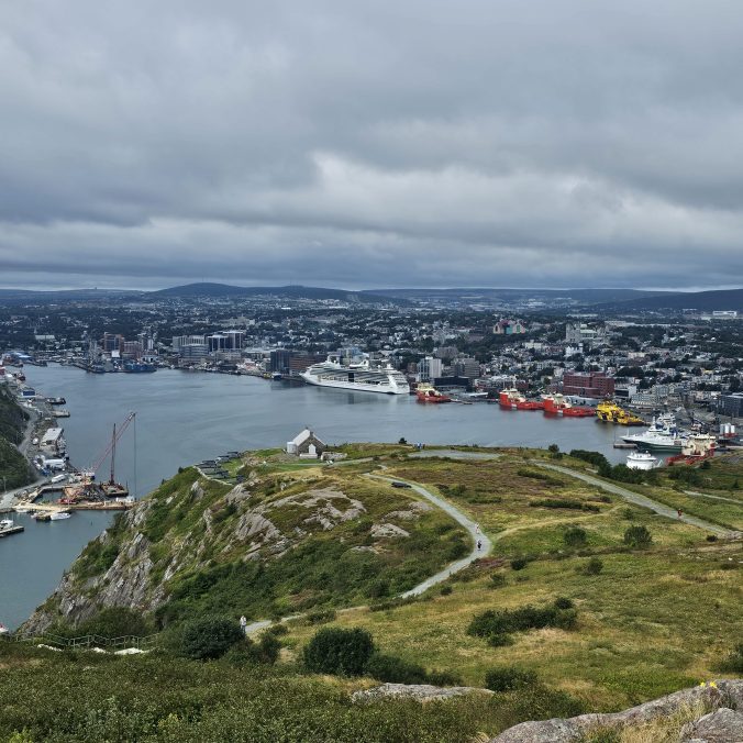 A photo of the city of St. John's, Newfoundland, as seen from Signal Hill overlooking the harbour and Atlantic Ocean.