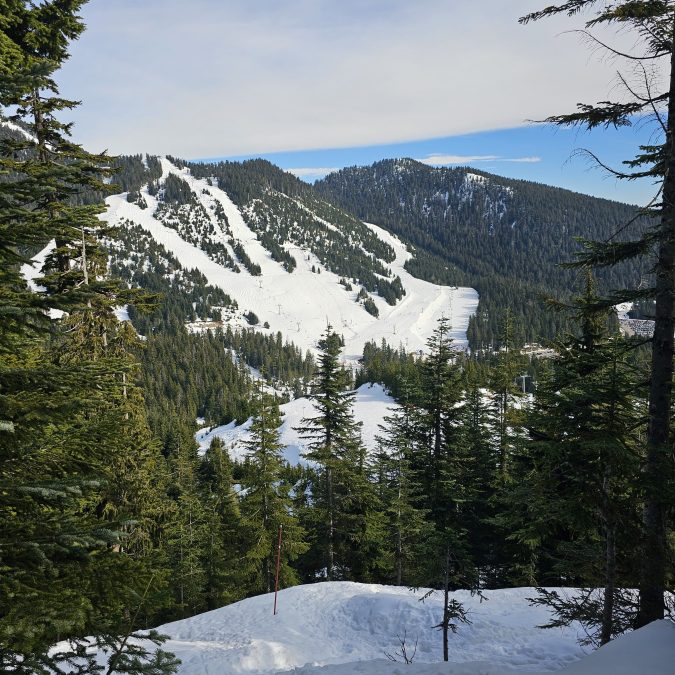 The view of Cypress Mountain ski resort from Black Mountain in the winter along the snowshoe trail near Vancouver, BC.